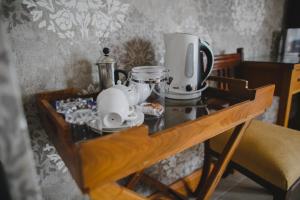 a table with a coffee maker on top of it at Strand House in Portstewart