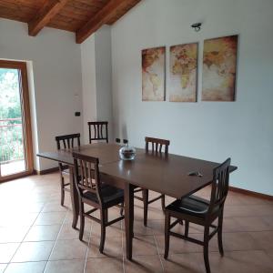 a dining room with a wooden table and chairs at Villa Di Gioia in Caccuri