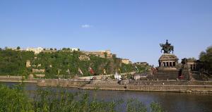 a statue in front of a river with flags at Hotel Berghof by 42 in Koblenz