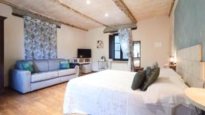 a large bedroom with a bed and a couch at A Casa di Anna in Cortemilia