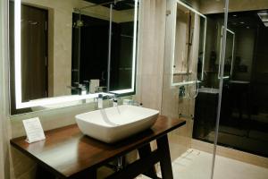 a bathroom with a white sink and a shower at Brightland Resort & Spa in Mahabaleshwar