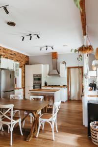 a kitchen and dining room with a wooden table and chairs at Redgate Homestead in Hartley