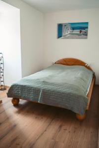 a bed in a bedroom with a wooden floor at Apartment Hainfeld in Hainfeld