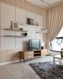 a living room with a television on a wooden cabinet at Pavilion Premier Suite Puchong - 6-7pax 3R2B in Puchong