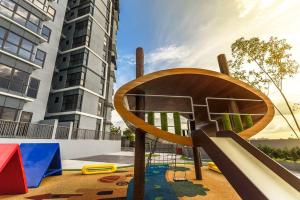 a playground with a slide in front of a building at Pavilion Premier Suite Puchong - 6-7pax 3R2B in Puchong