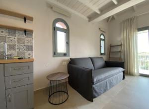 a living room with a couch and a table at PargaMondo Countryliving in Parga