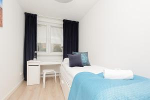 a bedroom with two beds and a desk and a window at Two-Bedroom Apartament Gdansk 650 m Brzeźno Beach by Noclegi Renters in Gdańsk