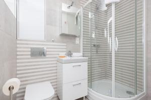 a bathroom with a shower and a sink and a toilet at Two-Bedroom Apartament Gdansk 650 m Brzeźno Beach by Noclegi Renters in Gdańsk