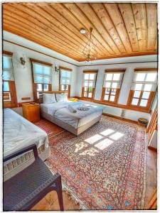 um quarto grande com 2 camas e um tapete em Muhsin Bey Konağı em Safranbolu