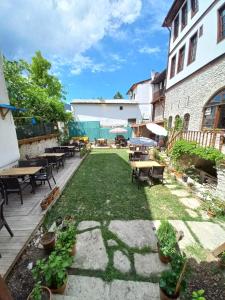 a patio with tables and chairs and grass at Muhsin Bey Konağı in Safranbolu