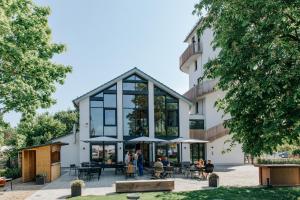 a building with people sitting outside of it at Village Turmzimmer in Kehl am Rhein