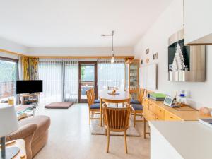 a kitchen and living room with a table and chairs at Apartment in Tauplitz with sauna and pool in Tauplitz