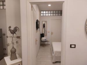 a hallway with a chicken ornament on the wall and a desk at PIAZZETTA la MADDALENA 2 in Savona +37 photos