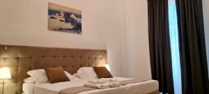 A bed or beds in a room at Home De Curtis
