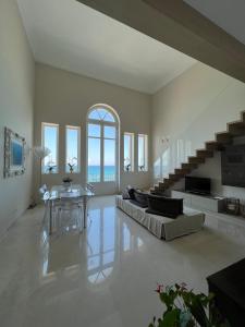 a living room with a couch and a table at Luxury Loft on the Sea in Trapani