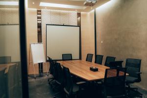 a conference room with a wooden table and chairs at Amigo Hotel Bintulu in Bintulu