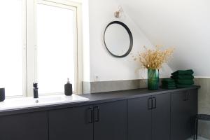 a bathroom with a sink and a mirror at Lotsvillan in Höllviken