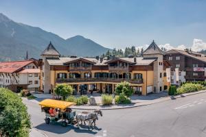 a horse drawn carriage in front of a building at Apartment Torri di Seefeld in Seefeld in Tirol