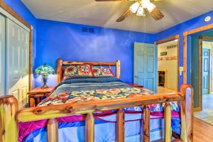 een slaapkamer met een houten bed in een blauwe kamer bij Waterfront Saginaw Bay Retreat with Boat Dock! 