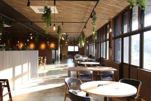 a row of tables and chairs in a restaurant at 宮若温泉郷 宮若虎の湯 Miyawaka Toranoyu in Miyawaka