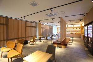 宫若市宮若温泉郷 宮若虎の湯 Miyawaka Toranoyu的一个带桌椅和桌上电脑的等候区