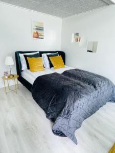 a bedroom with a bed with a black comforter at aday - Harbor Groundfloor Own Entrance - Studio in Aalborg