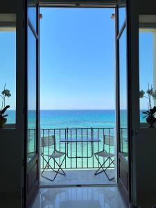a room with a view of the ocean from a balcony at Luxury Loft on the Sea in Trapani