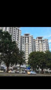 a large white building with cars in front of it at S PICE Arena Homestay in Bayan Lepas
