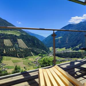 a balcony with a view of a valley and mountains at Großstahlhof Mountain & Panorama View in San Giovanni in Val Aurina