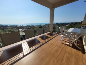 a balcony with a table and chairs and a view at Apartments Sunset Paradise in Makhinjauri