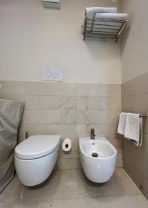 a bathroom with a white toilet and a sink at Luxury Loft on the Sea in Trapani