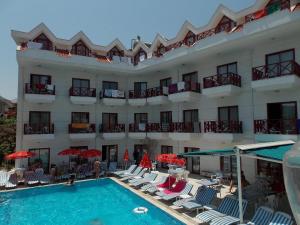a hotel with a swimming pool in front of a building at HİMEROS BEACH HOTEL in Kemer