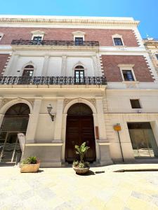 a large building with a balcony on top of it at Luxury Loft on the Sea in Trapani
