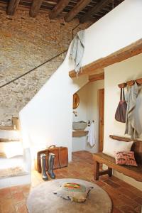 a room with a staircase with a rug and a table at Can Bassa in Madremanya