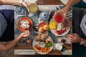 a group of people sitting at a table with plates of food at Boutique Hotel Galatea in Rome