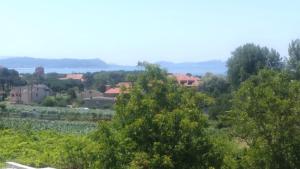 a view of a town from a hill with trees at Chalet con vista a las Islas Cíes in Sanxenxo