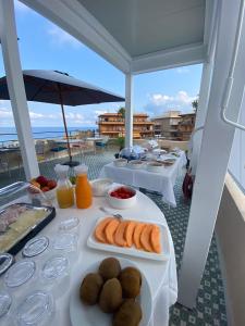 a table with plates of food on a balcony at NoOne Tropea Guesthouse in Tropea