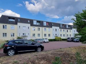 a black car parked in front of a building at Apartment mea in Berlin