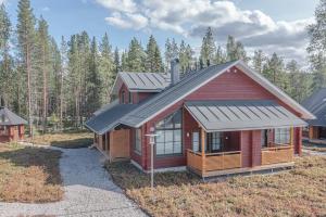 a small red house with a metal roof at Levillas Sointuilevi 1B66, 2 ski pass included in Levi