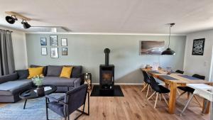 a living room with a couch and a dining room table at Ferienhaus Seeoase - 70qm - Kamin -Terrassen - Parkplatz - Badestelle fußläufig in Joachimsthal