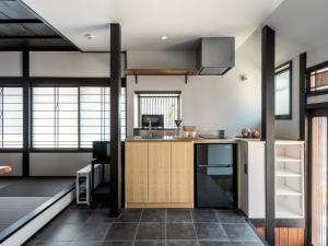 a kitchen with a sink and a counter top at Sansuikyo Machiya House in Kanazawa