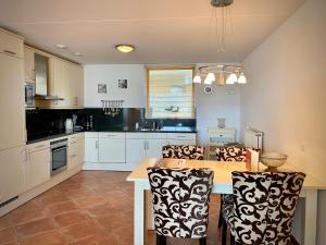 a kitchen with a table and chairs in it at Callantsoger Staete A109 in Callantsoog