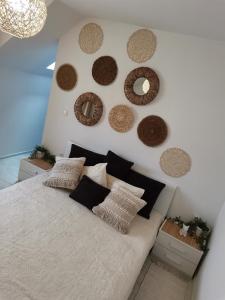 a bedroom with a bed with a bunch of wreaths on the wall at Sweety in Sliven
