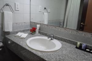 a bathroom counter with a sink and a mirror at WANASA CONTINENTAL HOTEL in Muscat +43 photos