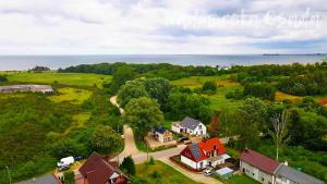 an overhead view of a house with a road leading to a field at Nadmorska Osada in Osłonino