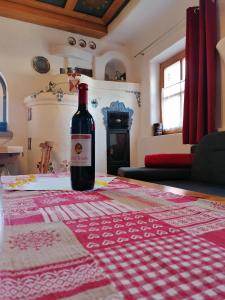 a bottle of wine sitting on top of a table at Märchenschlössel Altenstein in Trebesing