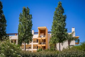 a building with two trees in front of it at Laguna - Vilamoura in Vilamoura