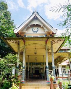 a large building with a clock on top of it at nDalem Natan Royal Heritage in Yogyakarta