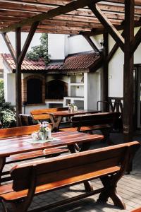 a group of picnic tables on a patio at Hotel Farma in Pelhřimov