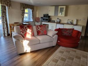 a living room with a couch and a kitchen at The Annexe in Ulverston